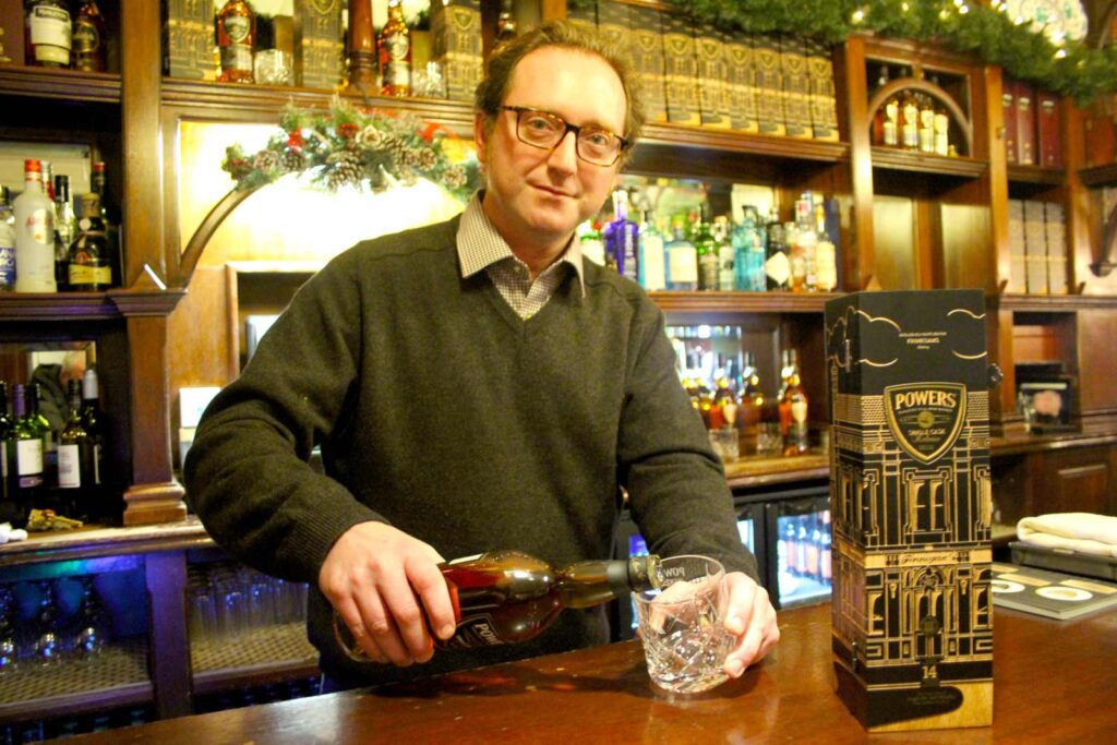 Alan Finnegan pours Finnegan's Whiskey