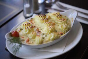 Finnegan's traditional fish pie topped with golden, oven-baked mashed potatoes, served hot and freshly prepared.